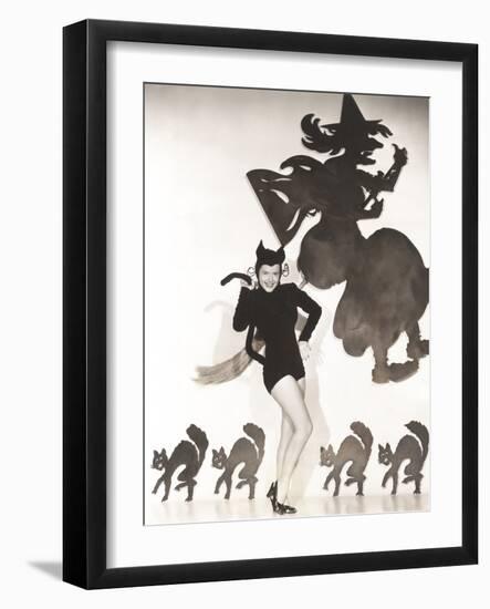 Woman in Cat Costume Posing Against Halloween Themed Wall-null-Framed Photo