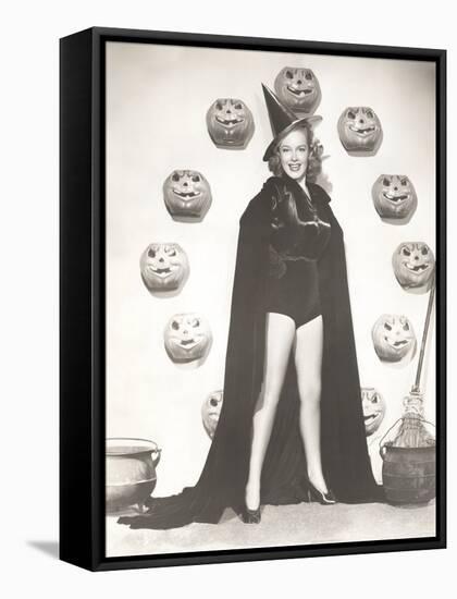 Woman in Witch Costume Surrounded by Carved Pumpkins-null-Framed Stretched Canvas