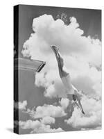 Woman jumping from springboard-null-Stretched Canvas