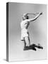 Woman Jumping into the Air with a Tennis Racket in Her Hand-null-Stretched Canvas