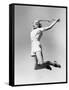 Woman Jumping into the Air with a Tennis Racket in Her Hand-null-Framed Stretched Canvas