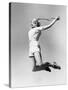 Woman Jumping into the Air with a Tennis Racket in Her Hand-null-Stretched Canvas