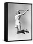 Woman Jumping into the Air with a Tennis Racket in Her Hand-null-Framed Stretched Canvas