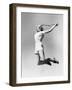 Woman Jumping into the Air with a Tennis Racket in Her Hand-null-Framed Photo