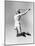 Woman Jumping into the Air with a Tennis Racket in Her Hand-null-Mounted Photo