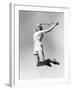 Woman Jumping into the Air with a Tennis Racket in Her Hand-null-Framed Photo