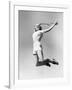 Woman Jumping into the Air with a Tennis Racket in Her Hand-null-Framed Photo