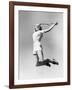 Woman Jumping into the Air with a Tennis Racket in Her Hand-null-Framed Photo