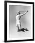 Woman Jumping into the Air with a Tennis Racket in Her Hand-null-Framed Photo