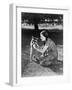 Woman Kneeling on the Lawn Playing with a Tame Raccoon-null-Framed Photo
