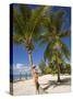 Woman Leaning Against Palm Tree, Princess Cays, Eleuthera Island, West Indies, Caribbean-Richard Cummins-Stretched Canvas