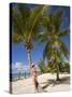 Woman Leaning Against Palm Tree, Princess Cays, Eleuthera Island, West Indies, Caribbean-Richard Cummins-Stretched Canvas