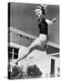 Woman Leaping over a Tennis Net-null-Stretched Canvas