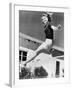 Woman Leaping over a Tennis Net-null-Framed Photo