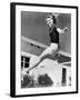 Woman Leaping over a Tennis Net-null-Framed Photo