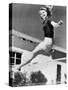 Woman Leaping over a Tennis Net-null-Stretched Canvas