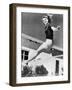 Woman Leaping over a Tennis Net-null-Framed Photo