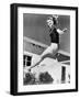 Woman Leaping over a Tennis Net-null-Framed Photo