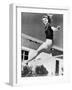 Woman Leaping over a Tennis Net-null-Framed Photo