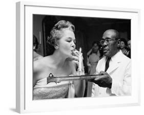 Woman Lighting a Cigarette from a Candle Held by a Waiter at the Piedmont Ball-Paul Schutzer-Framed Photographic Print