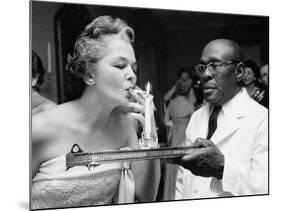 Woman Lighting a Cigarette from a Candle Held by a Waiter at the Piedmont Ball-Paul Schutzer-Mounted Photographic Print