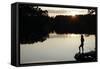 Woman looking out across a lake in rural Finland-David Pickford-Framed Stretched Canvas