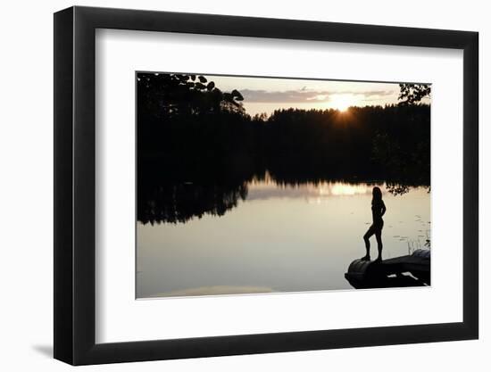 Woman looking out across a lake in rural Finland-David Pickford-Framed Premium Photographic Print