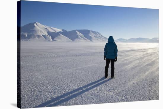 Woman Looking Up Adventdalen Valley at Sunrise-Stephen Studd-Stretched Canvas