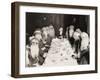 Woman Lunching with Twelve Santa Clauses-null-Framed Photo