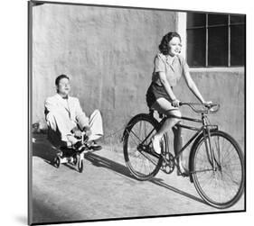 Woman on Bicycle Man Tricycle-null-Mounted Art Print