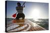 Woman on Stand Up Paddle-Board Heads into the Sunset at San Onofre Beach, San Clemente, California-Louis Arevalo-Stretched Canvas