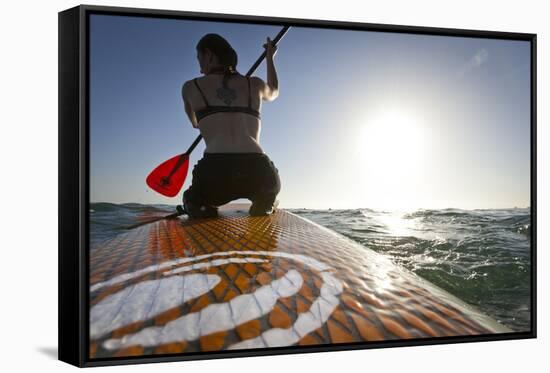 Woman on Stand Up Paddle-Board Heads into the Sunset at San Onofre Beach, San Clemente, California-Louis Arevalo-Framed Stretched Canvas