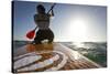 Woman on Stand Up Paddle-Board Heads into the Sunset at San Onofre Beach, San Clemente, California-Louis Arevalo-Stretched Canvas