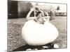 Woman Popping Out of Giant Egg-null-Mounted Photo