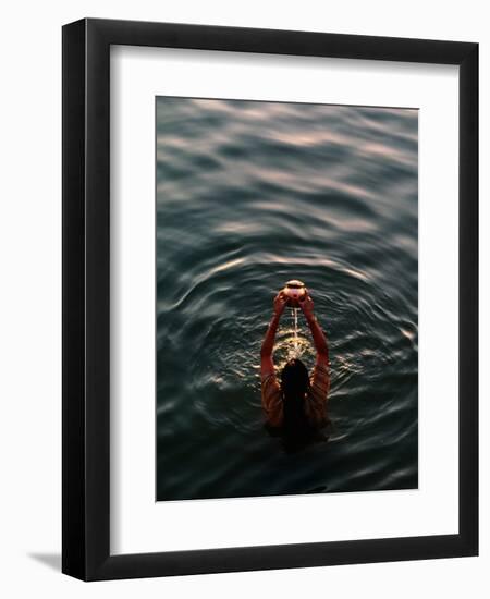 Woman Pouring Water During Morning Puja on Ganges, Varanasi, India-Anthony Plummer-Framed Photographic Print