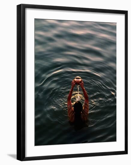 Woman Pouring Water During Morning Puja on Ganges, Varanasi, India-Anthony Plummer-Framed Photographic Print