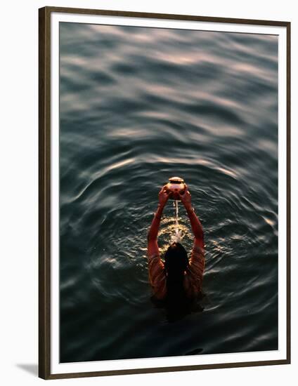 Woman Pouring Water During Morning Puja on Ganges, Varanasi, India-Anthony Plummer-Framed Photographic Print