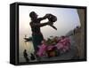 Woman Pouring Water Over Flowers on an Altar as a Religious Ritual, Varanasi, India-Eitan Simanor-Framed Stretched Canvas