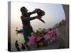 Woman Pouring Water Over Flowers on an Altar as a Religious Ritual, Varanasi, India-Eitan Simanor-Stretched Canvas