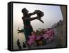 Woman Pouring Water Over Flowers on an Altar as a Religious Ritual, Varanasi, India-Eitan Simanor-Framed Stretched Canvas