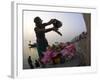 Woman Pouring Water Over Flowers on an Altar as a Religious Ritual, Varanasi, India-Eitan Simanor-Framed Photographic Print