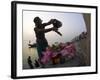 Woman Pouring Water Over Flowers on an Altar as a Religious Ritual, Varanasi, India-Eitan Simanor-Framed Photographic Print