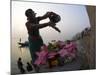 Woman Pouring Water Over Flowers on an Altar as a Religious Ritual, Varanasi, India-Eitan Simanor-Mounted Photographic Print