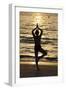 Woman practising yoga meditation on beach at sunset as concept for silence and relaxation-Godong-Framed Photographic Print