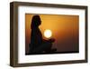 Woman practising yoga pose and meditation at sunset as concept for silence and relaxation-Godong-Framed Photographic Print