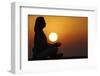 Woman practising yoga pose and meditation at sunset as concept for silence and relaxation-Godong-Framed Photographic Print