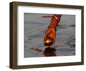 Woman Praying on the Banks of the River Ganges Fills Water into a Copper Vessel for a Ritual-null-Framed Photographic Print