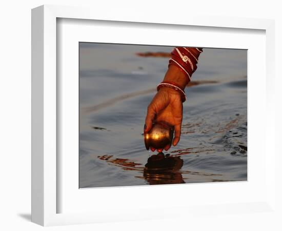 Woman Praying on the Banks of the River Ganges Fills Water into a Copper Vessel for a Ritual-null-Framed Photographic Print