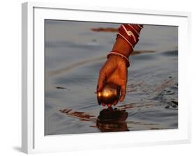 Woman Praying on the Banks of the River Ganges Fills Water into a Copper Vessel for a Ritual-null-Framed Photographic Print