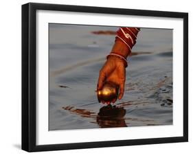 Woman Praying on the Banks of the River Ganges Fills Water into a Copper Vessel for a Ritual-null-Framed Photographic Print